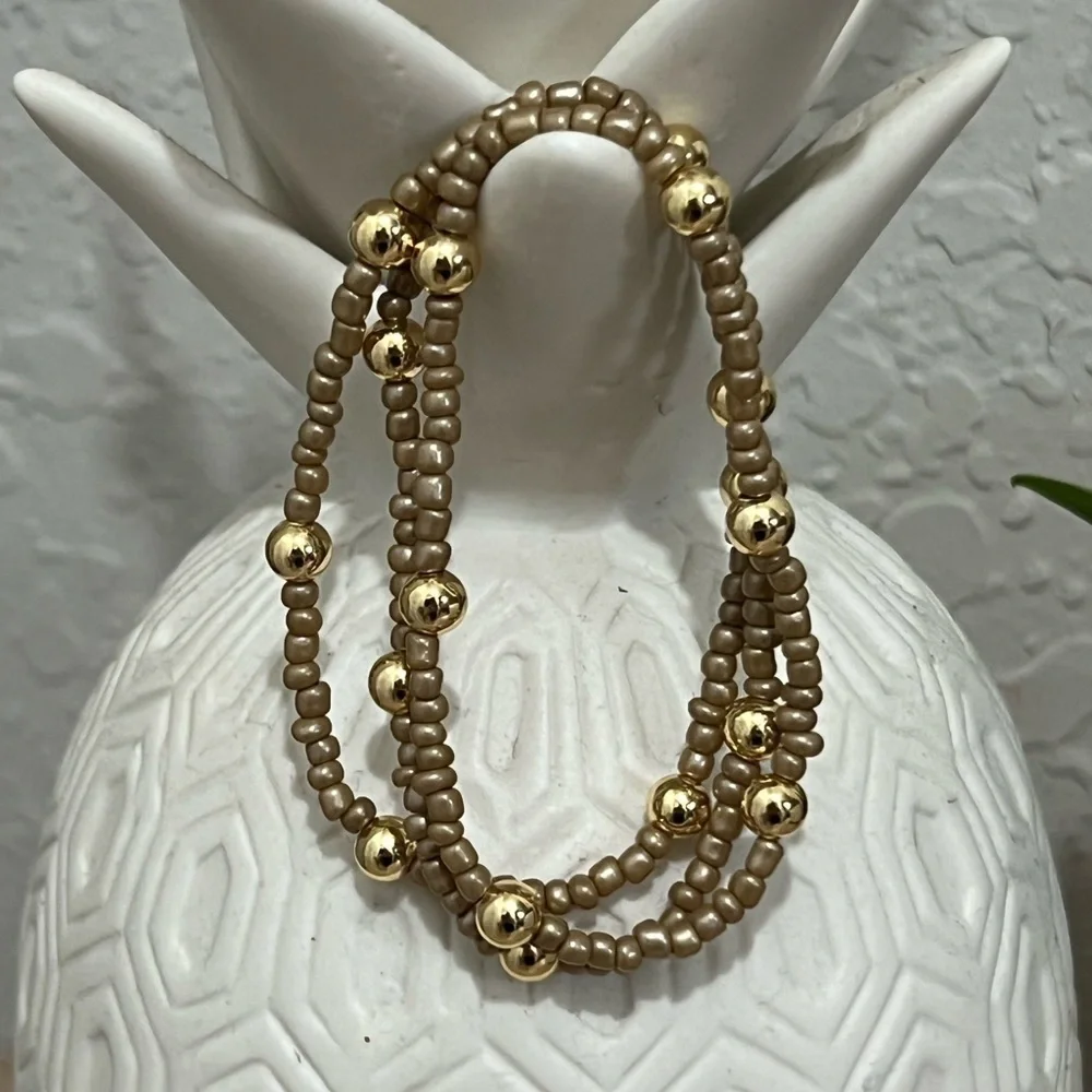 Brown/tan beaded bracelets with gold plated beads size 7”